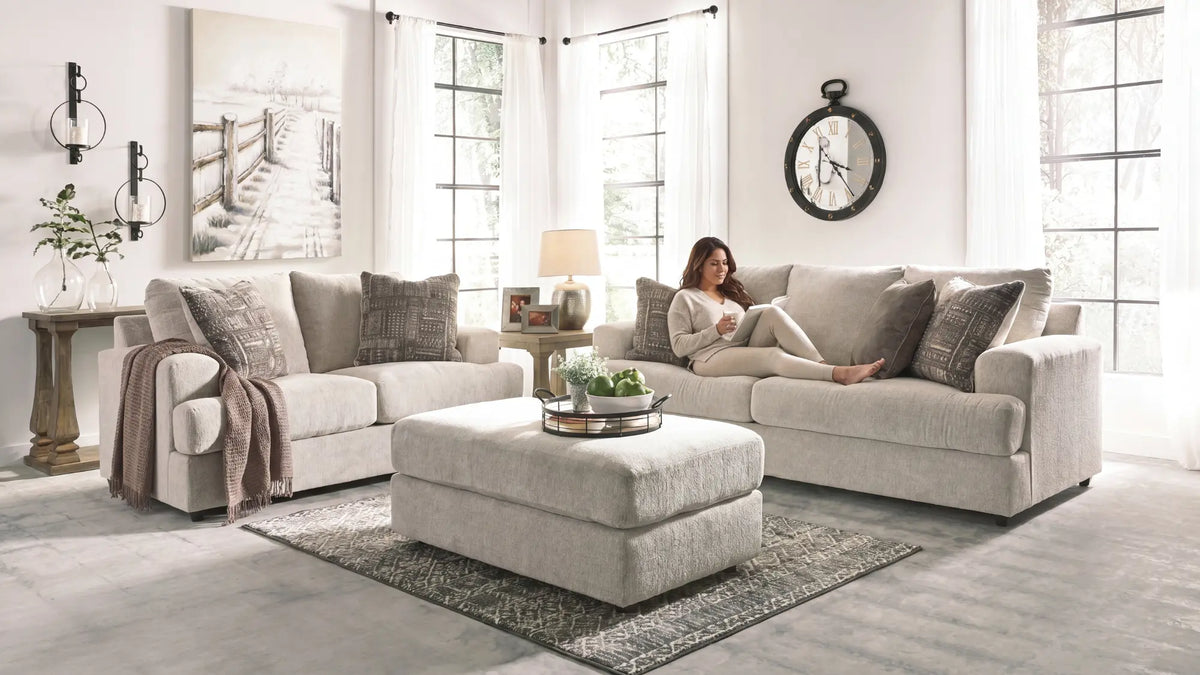 A woman lying cozy and reading a book in a sofa